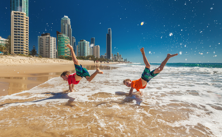 Two boys doing a handstand on the Gold Coast