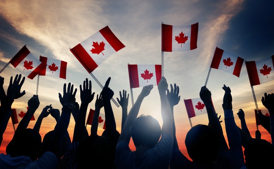 silhouettes-of-people-holding-flag-of-canada