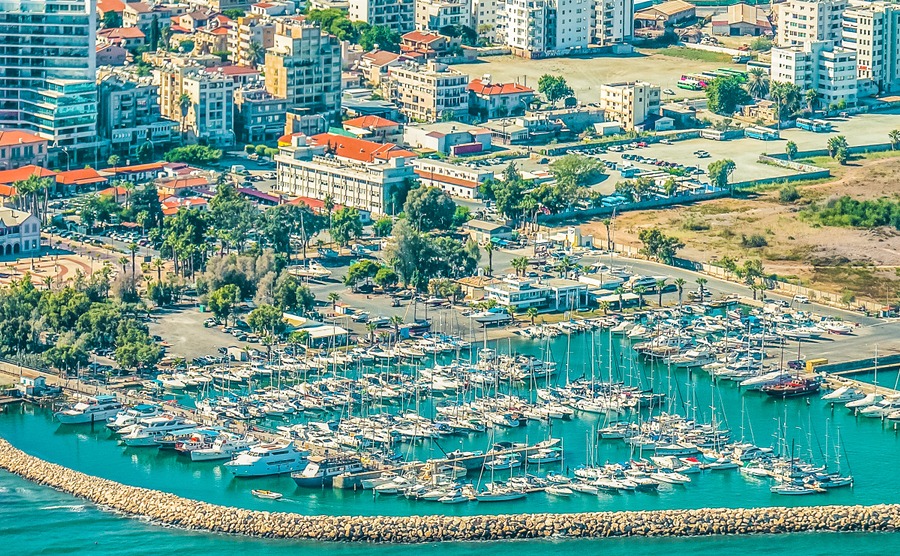 Sea port city of Larnaca, Cyprus. View from the aircraft to the coastline, beaches, seaport and the architecture of the city of Larnaca.