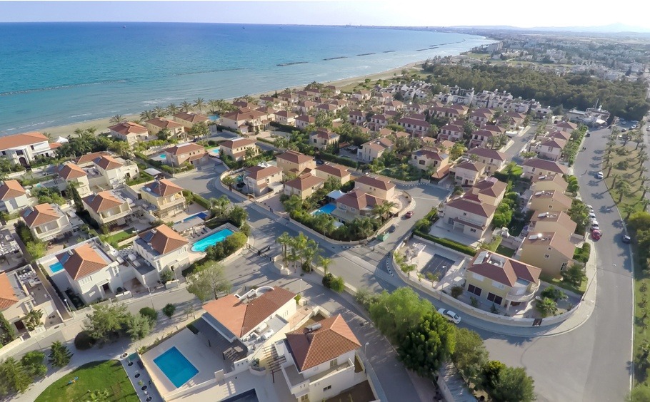 Elite cottage houses along Cyprus coastline, aerial view of beautiful seascape