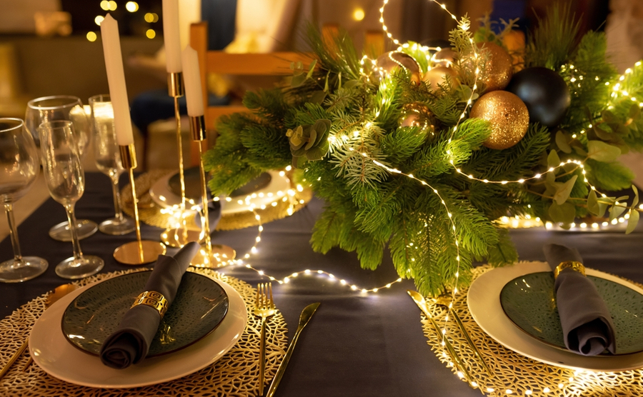 Beautiful table setting with Christmas decorations. Garland on the table