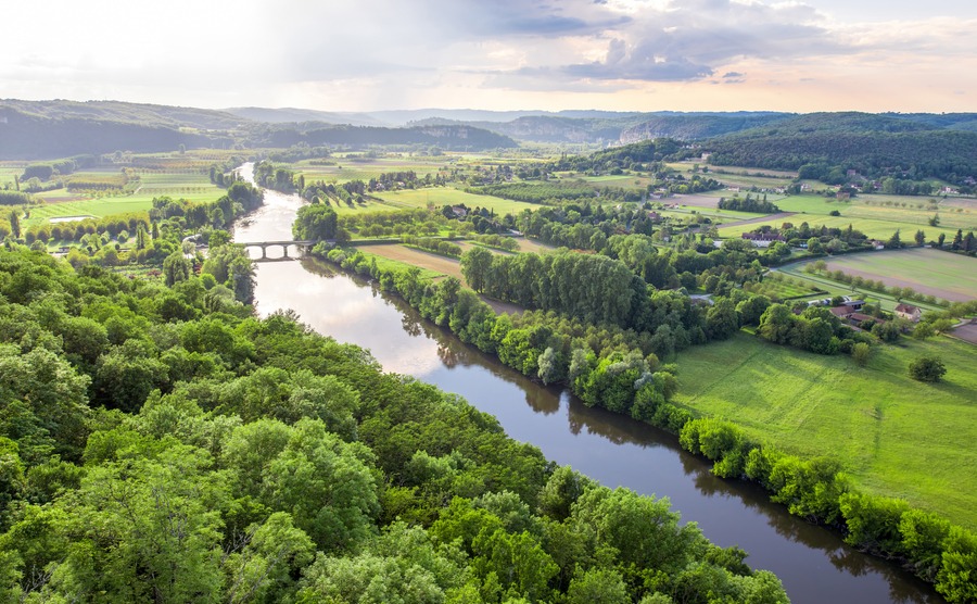 Aerial landscape view on Dordogne river with the old bridge and beautiful fields near Domme village in France