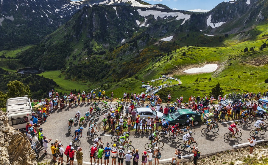 PORT DE PAILLERES,FRANCE- JUL 6: The peloton climbing the road to Col de Pailheres in Pyrenees Mountains during the stage 8 of the 100 edition of Le Tour de France on July 6, 2013.