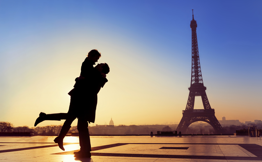 A couple under the eiffel tower in paris