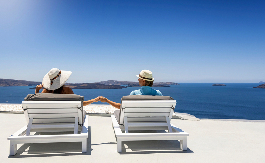 couple in greece, looking out to sea. 