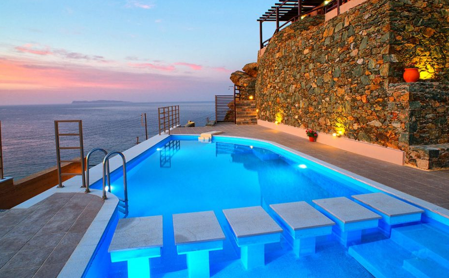 pool with luxury villa in the background.