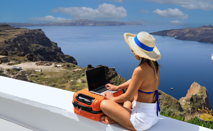 woman working on a laptop in Greece, scenic. 