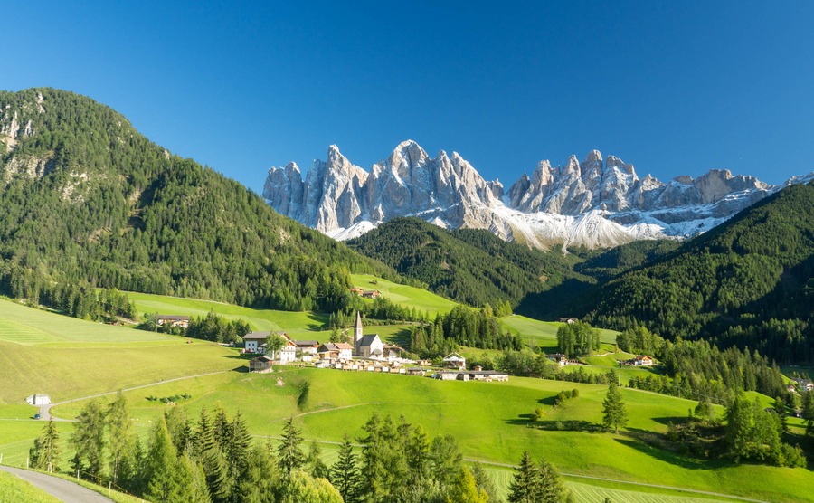 Colors of Dolomites. funes view of the valley, Puez-Odle in autumn. at sunset holy magdalena. View of odle mountain. Santa Maddalena, Tyrol, Italy. Green grass, mountains and blue sky. Summer