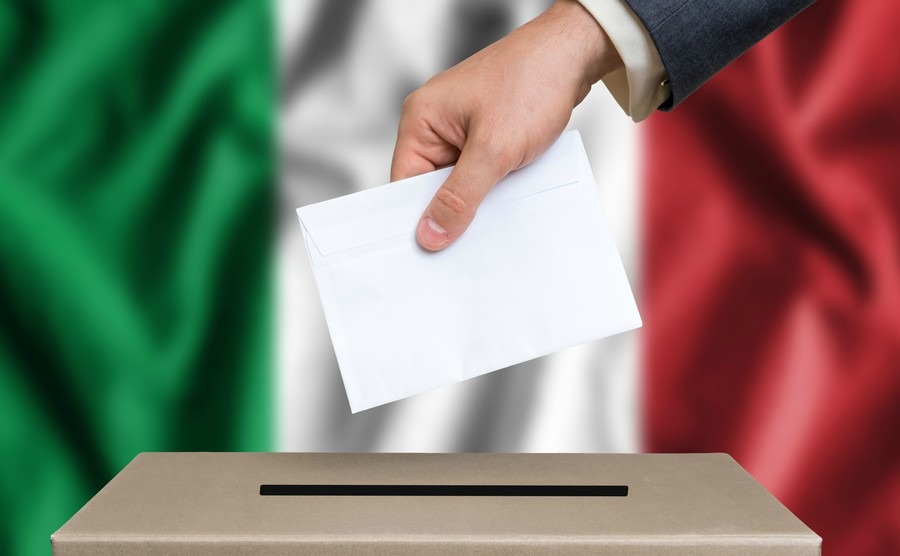 election-in-italy-the-hand-of-man-putting-his-vote-in-the-ballot-box-italian-flag-on-background