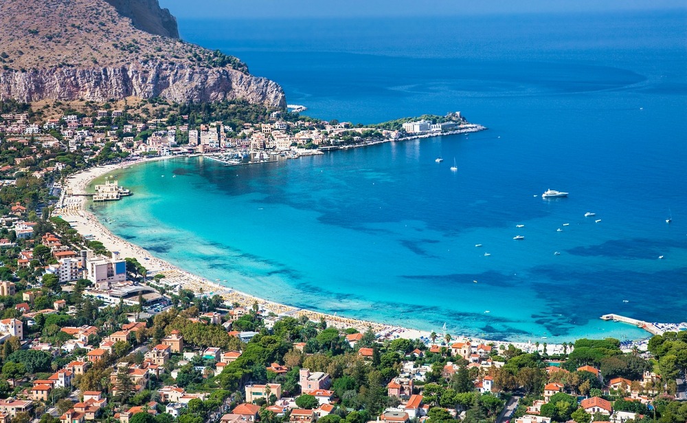 White sandy beaches like here at Mondello make Palermo another strong contender to buy property in Sicily in.