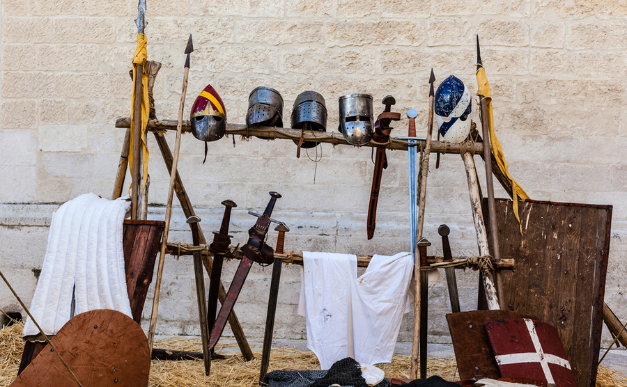 medieval shields, helm and weapons in a medieval fair in italy