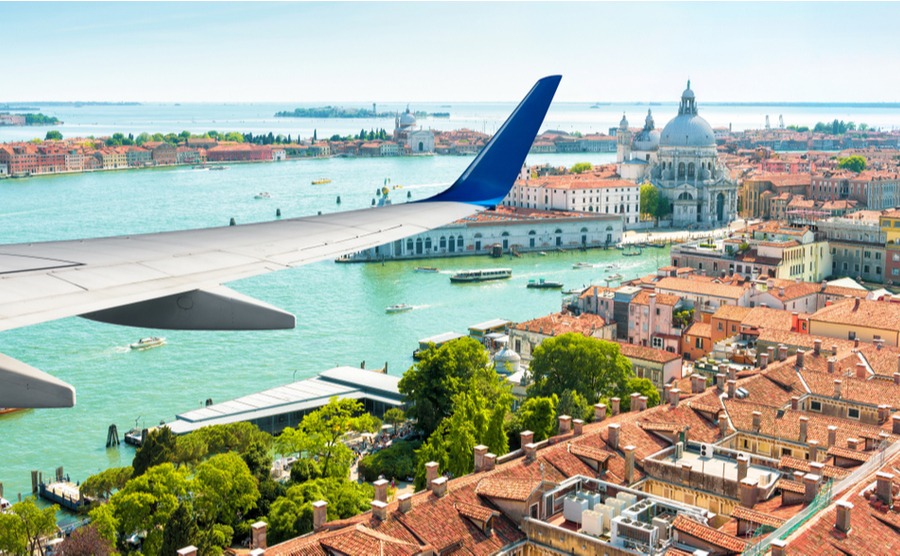 Plane flies above Venice, Italy.
