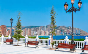 benches in the foreground; skyscrapers in the background in Benidorm.