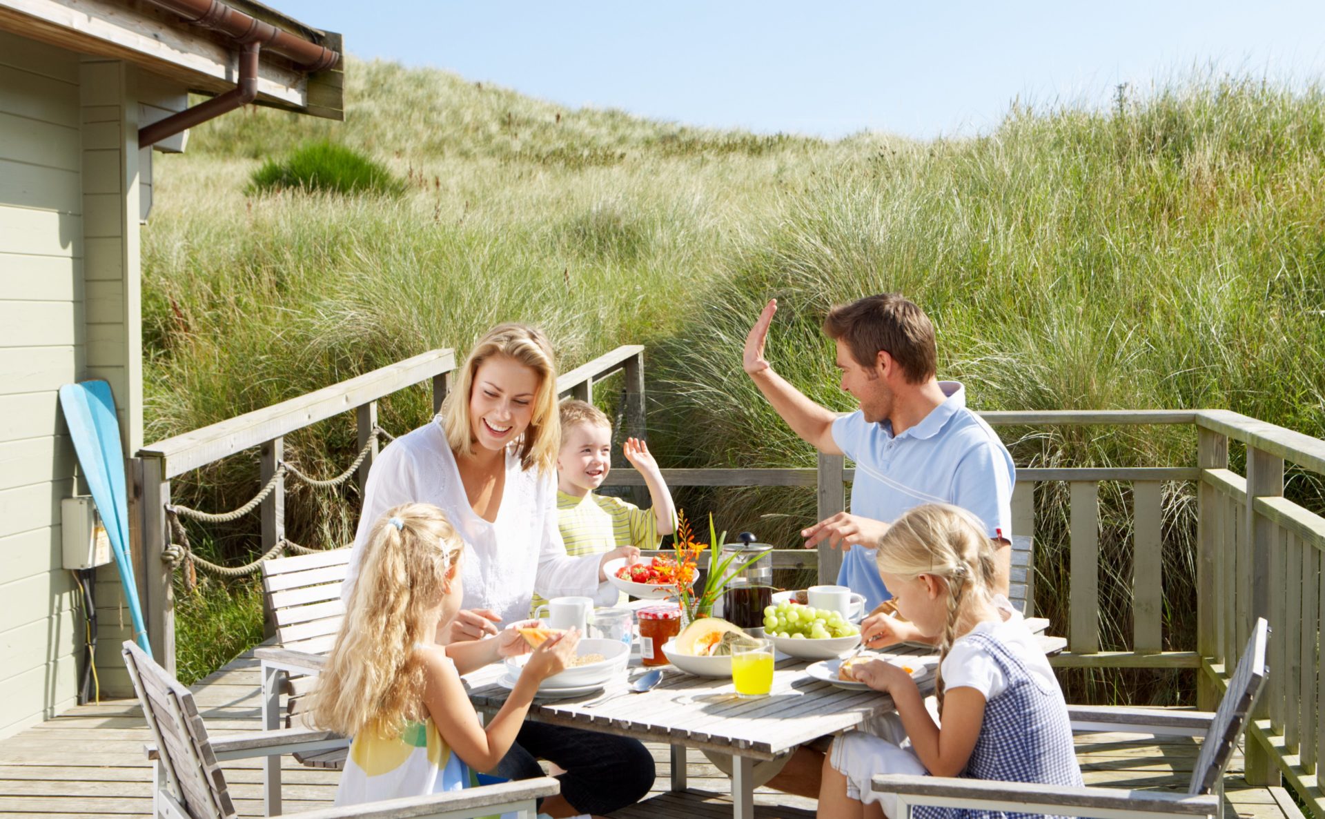 Family eating together on holiday | Buying a holiday home with family