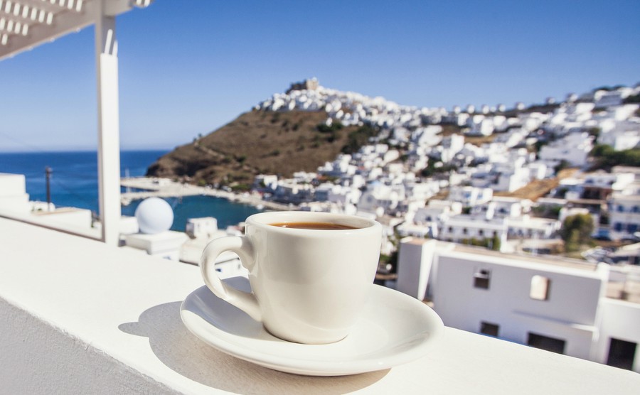 vacations-in-greece-traditional-greek-coffee-on-a-balcony-with-beautiful-greek-mediterranean-town-on-the-background
