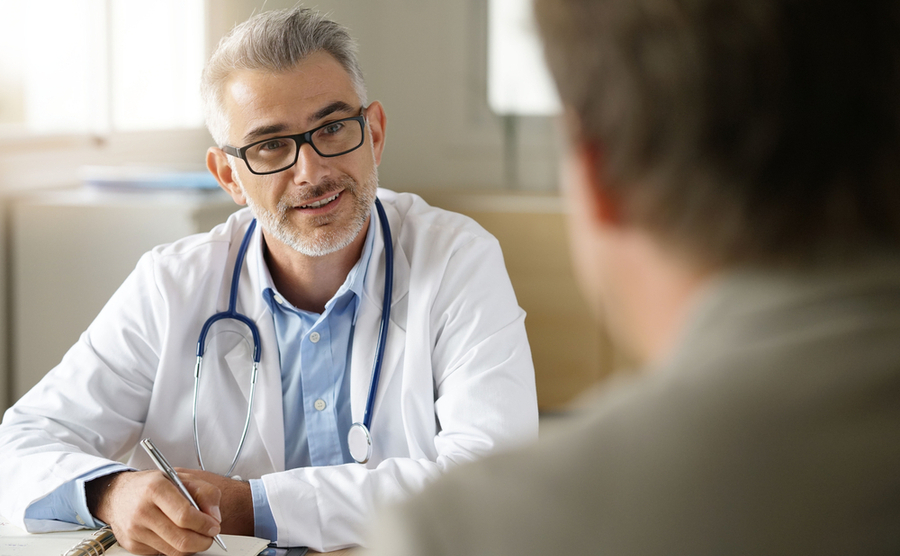 Doctor talking to patient in office