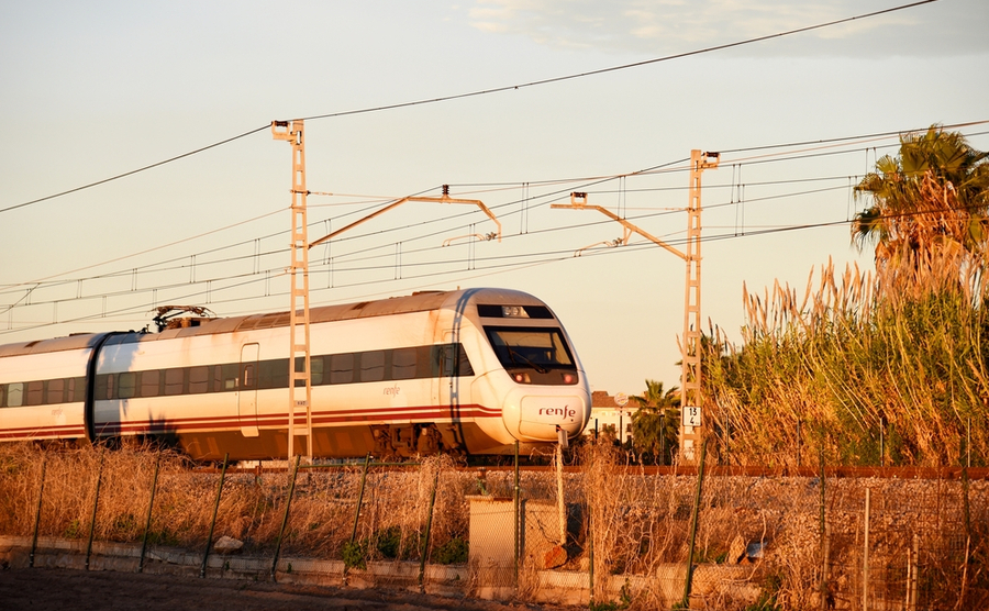 High-speed AVE train in motion on Valencia – Barcelona high-speed railway. RENFE SNCF - Spanish National Rail Network. AVE 103 High-speed train. December 16, 2021, Spain, Valencia.