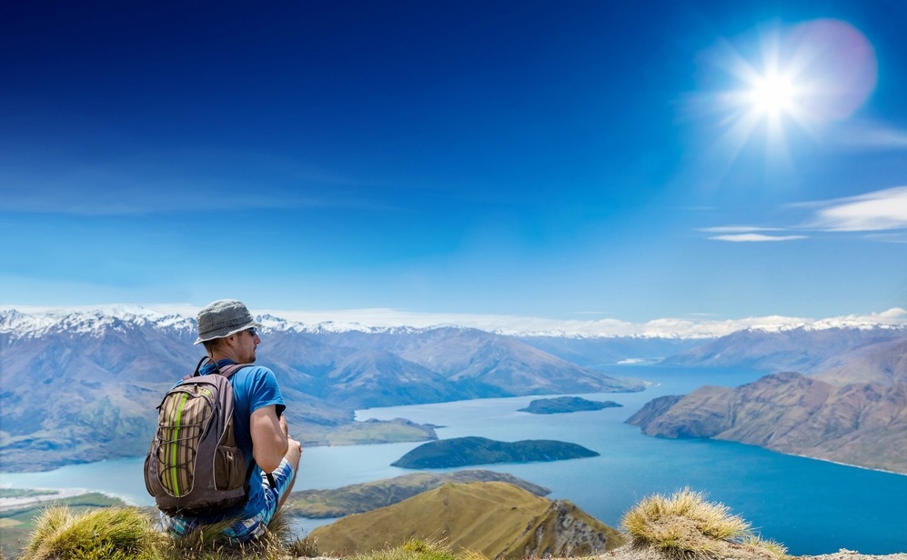 Tourist with a backpack and mountain panorama