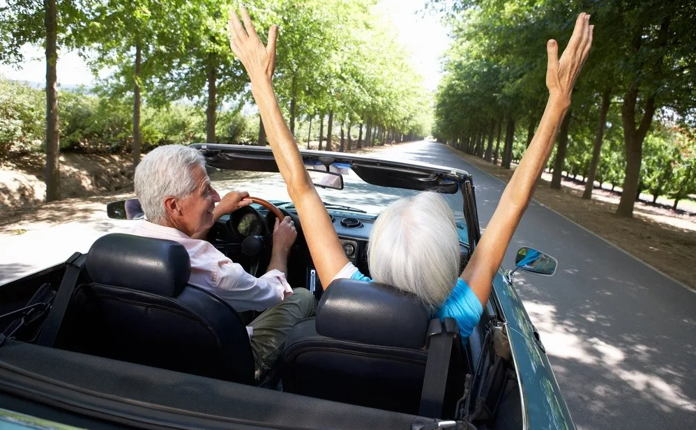 Retired couple driving in Portugal