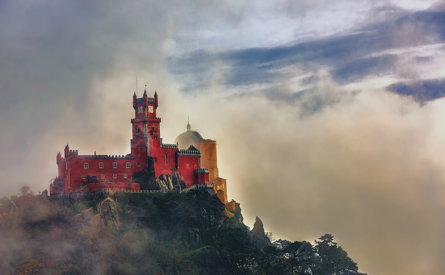 pena-national-palace-sintra-portugal-partly-covered-in-afternoon-fog-after-rain