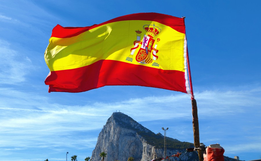 national-flag-of-spain-from-back-side-fluttering-in-wind-the-rock-of-gibraltar-in-background