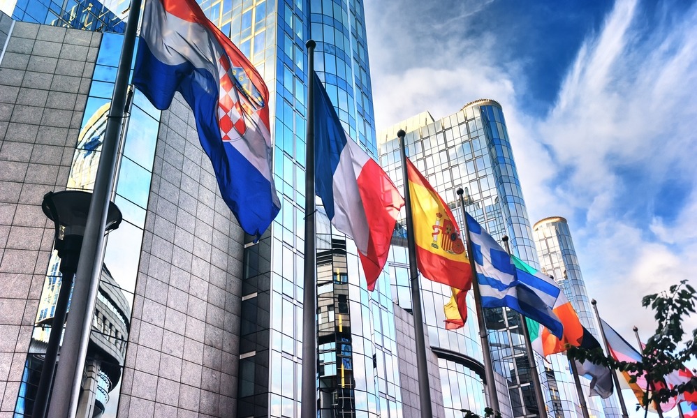 Spain - Waving flags in front of European Parliament building. Brussels, Belgium