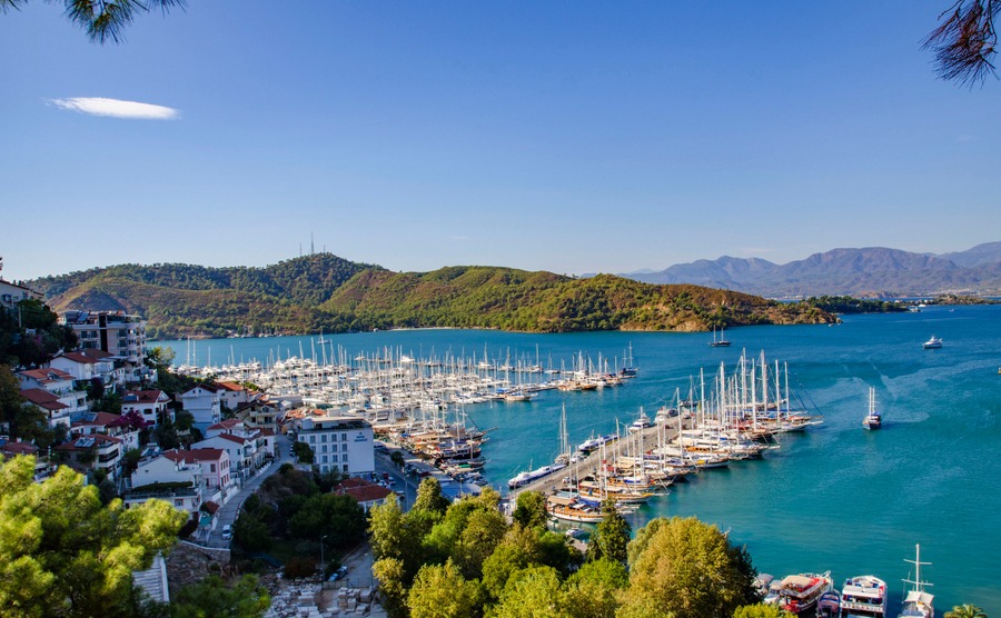 Turkey, Fethiye, view of the harbor with numerous yachts, and beautiful mountains in the background in the rays of the sun