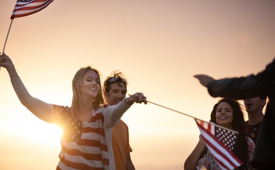 Group of Friends in their twenties dancing on the Beach at Sunset in California